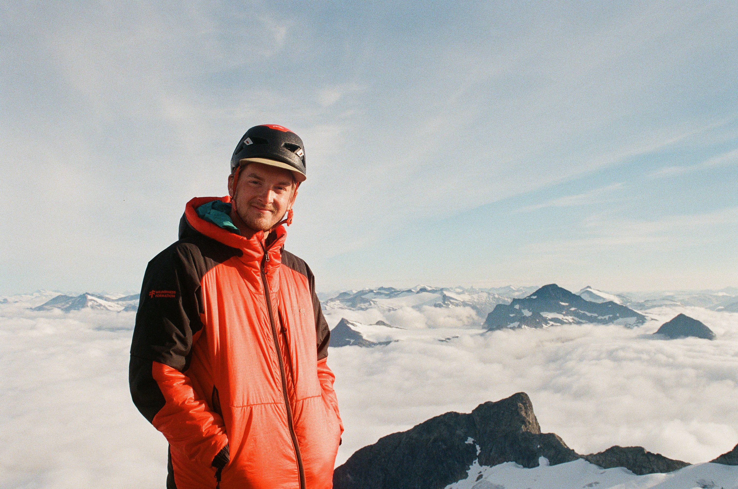 John Wayne Seitzler on a summit above the clouds
